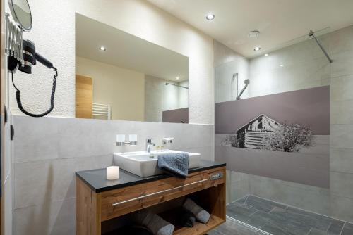 a bathroom with a sink and a mirror at Alpin Chalet am Burgsee in Ladis