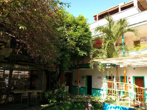 a hotel with a swimming pool in front of a building at Park Vil-la Apartelle in Manila