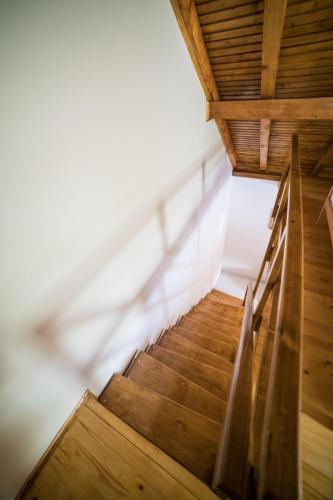 a staircase in a building with a wooden ceiling at Vila "Volujak" in Tjentište