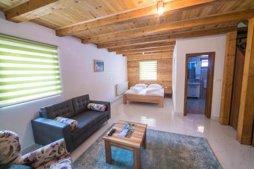 a living room with a couch and a table at Vila "Volujak" in Tjentište