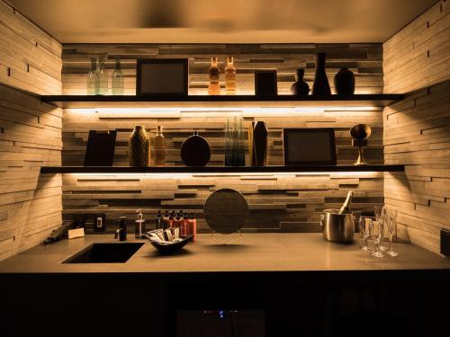 a kitchen with a counter with a sink and shelves at barhotel Hakone Kazan in Hakone