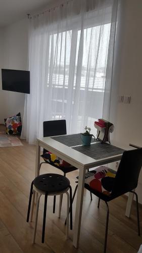 a dining table and chairs in a living room at Apartmány Tylovice in Rožnov pod Radhoštěm
