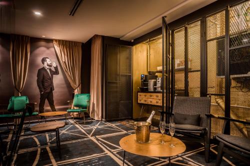 a room with tables and chairs and a man on the wall at Embassy Hotel Tel Aviv in Tel Aviv