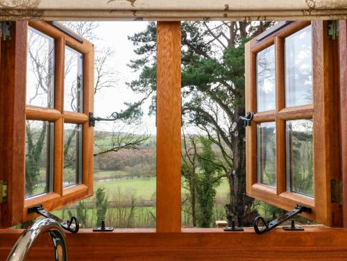 a window with a view of a golf course at Little Silver Leaf in High Bickington