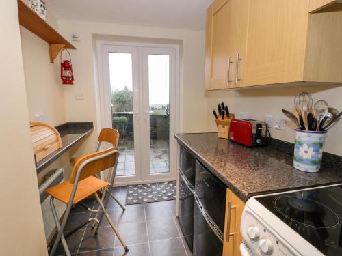a kitchen with a sink and a counter top at Edrydd in Harlech