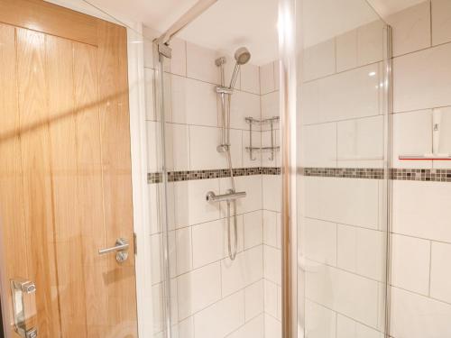 a bathroom with a shower with a glass door at Elliott's Retreat in Sheringham