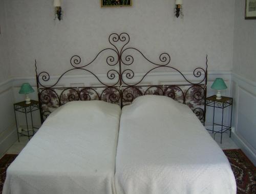 a bed with two white pillows on top of it at Le Chateau de Prauthoy in Prauthoy