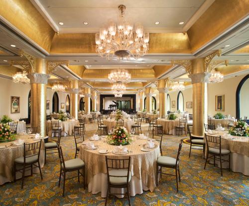 a ballroom with tables and chairs and a chandelier at The Taj Mahal Tower, Mumbai in Mumbai