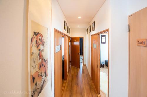 a hallway in a house with wooden floors and white walls at RUSUTSU HOLIDAY CHALET in Rusutsu