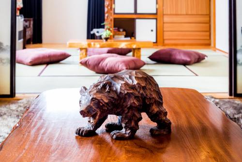 a statue of a dog sitting on top of a table at RUSUTSU HOLIDAY CHALET in Rusutsu