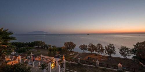 a view of a body of water at sunset at Laura Beach House in Alykes
