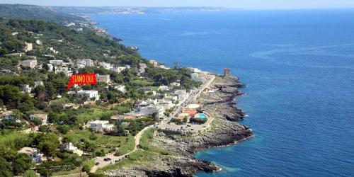 an aerial view of a small town on a hill near the water at Agriturismo Salento D'Arare in Marina Serra