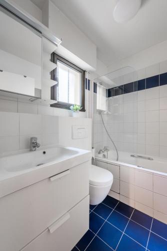 une salle de bain blanche avec un lavabo et des toilettes dans l'établissement Sweet Home Paris Apartment, à Paris