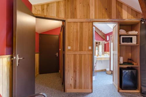 un couloir avec une porte menant à une chambre dans l'établissement L'Élassier, à Saint-Priest-sous-Aixe