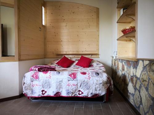 a bedroom with a bed with red pillows at CASA VACANZE SONIA in Amelia