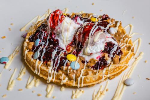 a waffle with ice cream and toppings on a table at Motel Felikitas in Laktaši