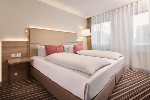 a large white bed in a hotel room at HYPERION Hotel Berlin in Berlin