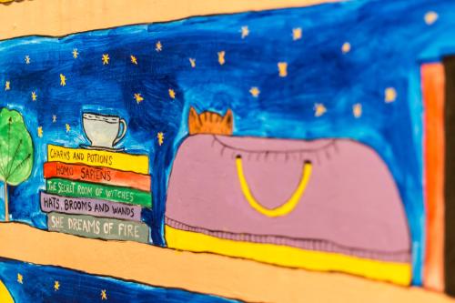 a bulletin board with a cartoon of a bag at Baroque Hostel & Coworking in Budapest