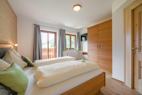 a bedroom with two beds and a window at Stockhambauer in Kleinarl