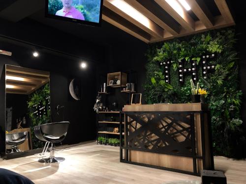 a room with a tv on a wall with plants at Hotel Pamela Concept in Negotino