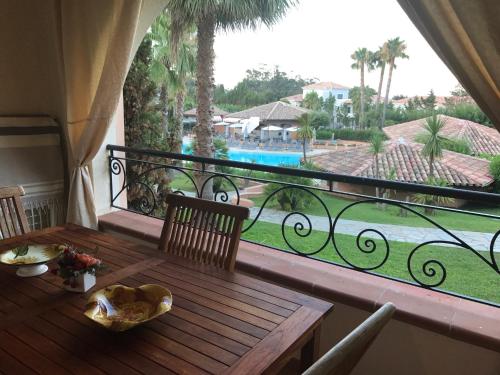 d'un balcon avec une table et une vue sur la piscine. dans l'établissement sognu di mare, à Linguizzetta