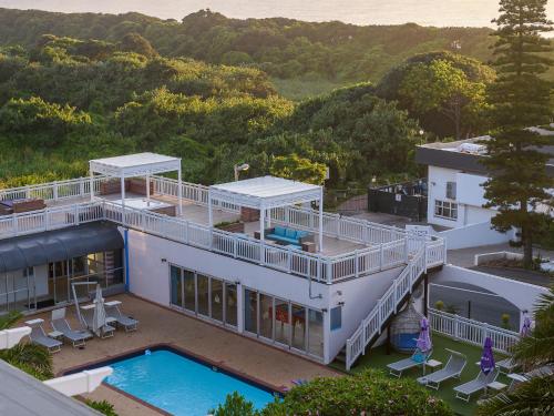 an aerial view of a house with a swimming pool at Umhlanga Cabanas in Durban