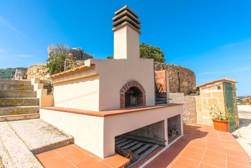a small building with a tower on top of it at Appartamenti Bellavista - HelloElba in Portoferraio