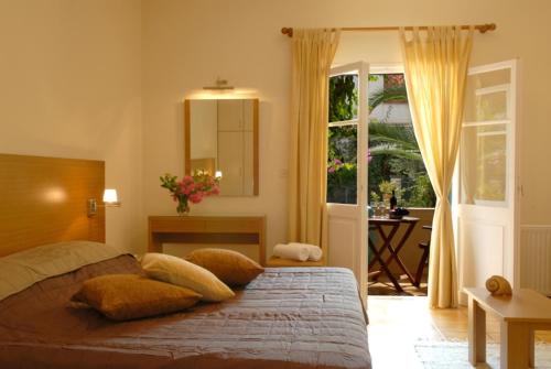 a bedroom with a bed with pillows on it at Romanos apartments in Gaios