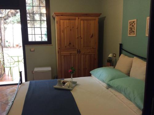 a bedroom with a bed and a table with flowers on it at Sweet Home & Apartments in Fontane Bianche