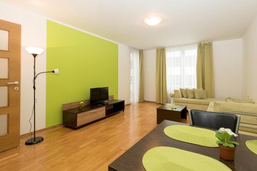 a living room with a couch and a tv at Aparthotel Angel in Prague