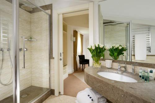 a bathroom with a sink and a shower at Maison Milano | UNA Esperienze in Milan