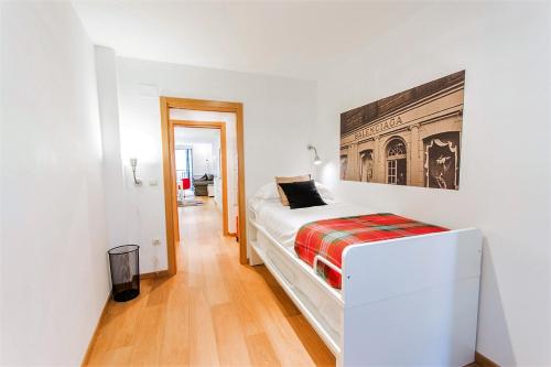 a bedroom with a bed and a painting on the wall at ATERIAN PELAIO ETXEA in Getaria