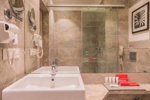a bathroom with a sink and a shower at Centre Point Navi Mumbai in Navi Mumbai