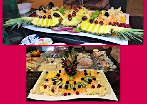 two plates filled with different types of food at M&A Cityhotel Hildesheim in Hildesheim