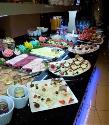a buffet with many different types of food on a table at M&A Cityhotel Hildesheim in Hildesheim