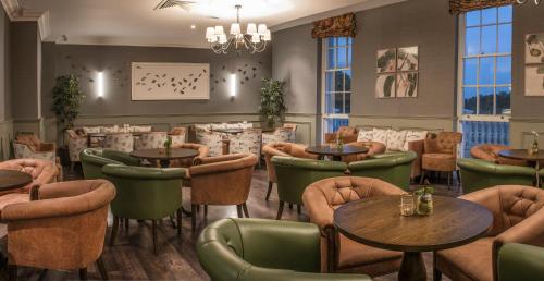 a restaurant with tables and chairs in a room at De Vere Wokefield Estate in Reading
