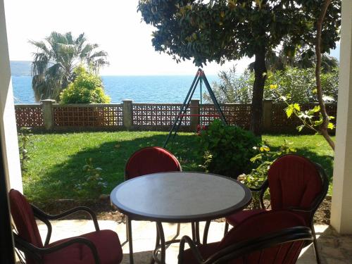 a table and chairs with a table and a swing at Apartmani Milosevic in Herceg-Novi