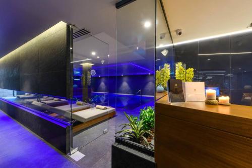a bathroom with a sink and an aquarium at Ajax Hotel in Limassol