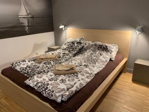 a bed with a blanket and a purse on it at Apartament na Klifie DUNE in Ustronie Morskie