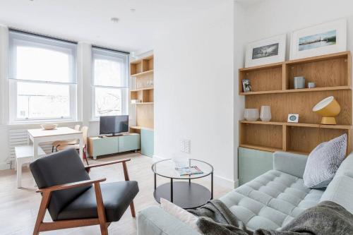 a living room with a couch and a table at Live like a Londoner by TOWER BRIDGE in London