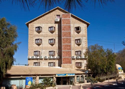 a tall building with windows on the side of it at Hotel Club Ramon in Mitzpe Ramon
