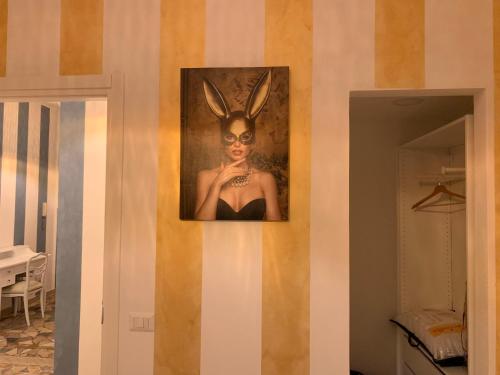 a painting of a woman with bunny ears on a wall at FiumicinoA57 in Fiumicino