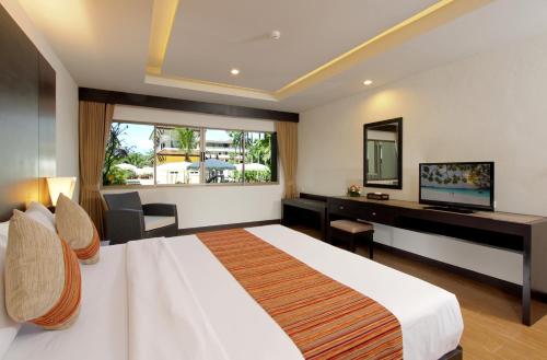 A bed or beds in a room at Kata Sea Breeze Resort - SHA Plus