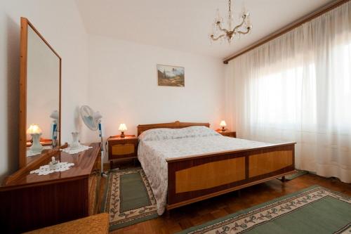 a bedroom with a bed and a dresser and a mirror at Apartment Patricia in Rovinj
