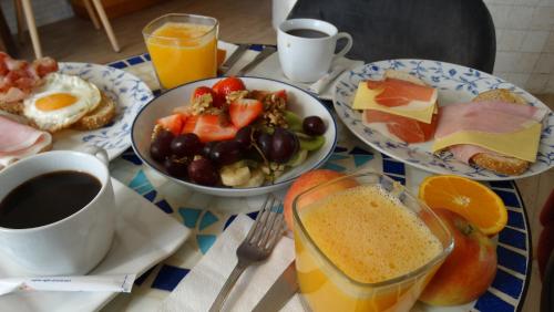 a table topped with plates of breakfast foods and drinks at Hostal La Paloma I in Calpe