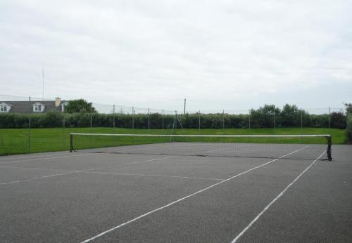 a tennis court with a net in the middle at Ballybunion Holiday Cottages No 21 by Trident Holiday Homes in Ballybunion