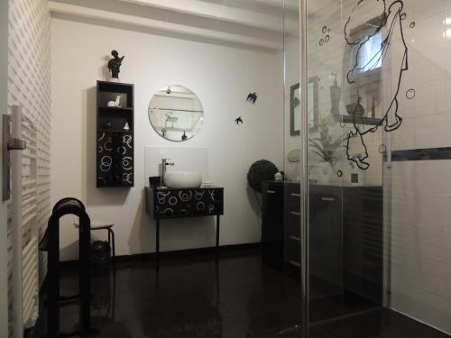 a bathroom with a glass shower and a sink at Fleur De Soleil in Saint-Jouin-Bruneval