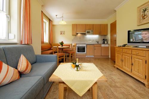 a living room with a couch and a table at Appartment Kinigadner in Pertisau