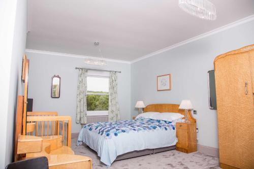 a bedroom with a bed and a window at The Globe Angle in Pembrokeshire