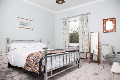 a bedroom with a bed and a window at The Globe Angle in Pembrokeshire